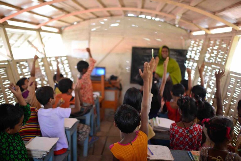 The boat has one classroom that holds about 30 kids. The walls are made of reeds. The lone computer runs off solar panels (image by Mahmud Hossain Opu via NPR)