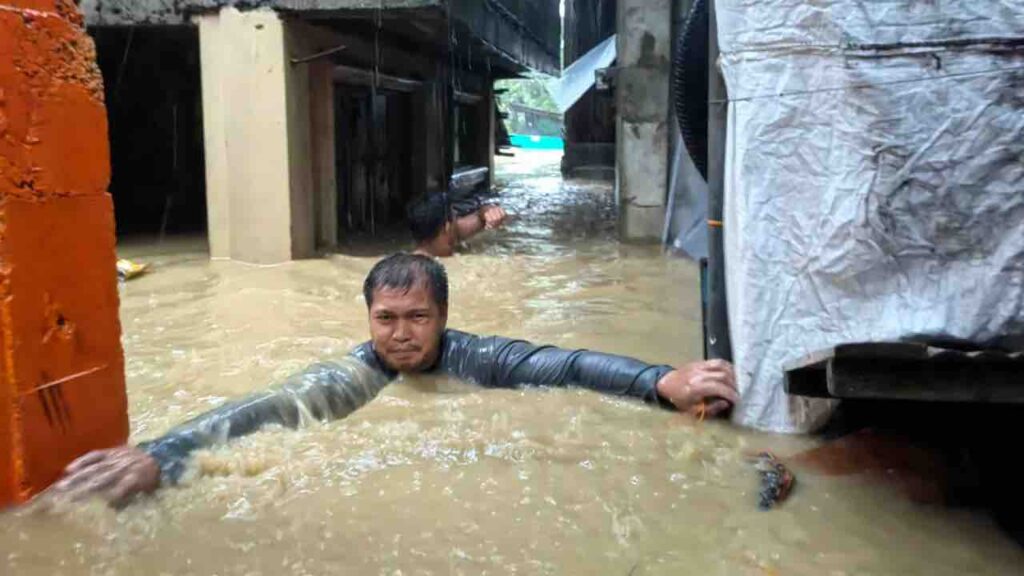 A man negotiates neck-deep floodwaters in Laoag city, Ilocos Norte province, northern Philippines. Bernie Sipin Dela Cruz/AP