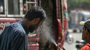 A volunteer sprays water on a passerby's face to cool him off on an unusually hot April day in Karachi, Pakistan. Photograph: Asif Hassan/AFP/Getty Images (2025)