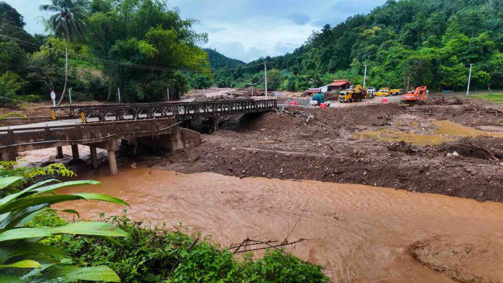 River basin- rural by Flooded River and Damaged Bridge by TEERASAK AINKEAW