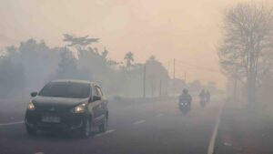 Motorists drive with headlights on a haze-shrouded road in Palangka Raya city, central Kalimantan on August 20, 2026, as smoke originating from widespread forest and land fires has significantly reduced visibility and degraded air quality across the province. — AFP pic