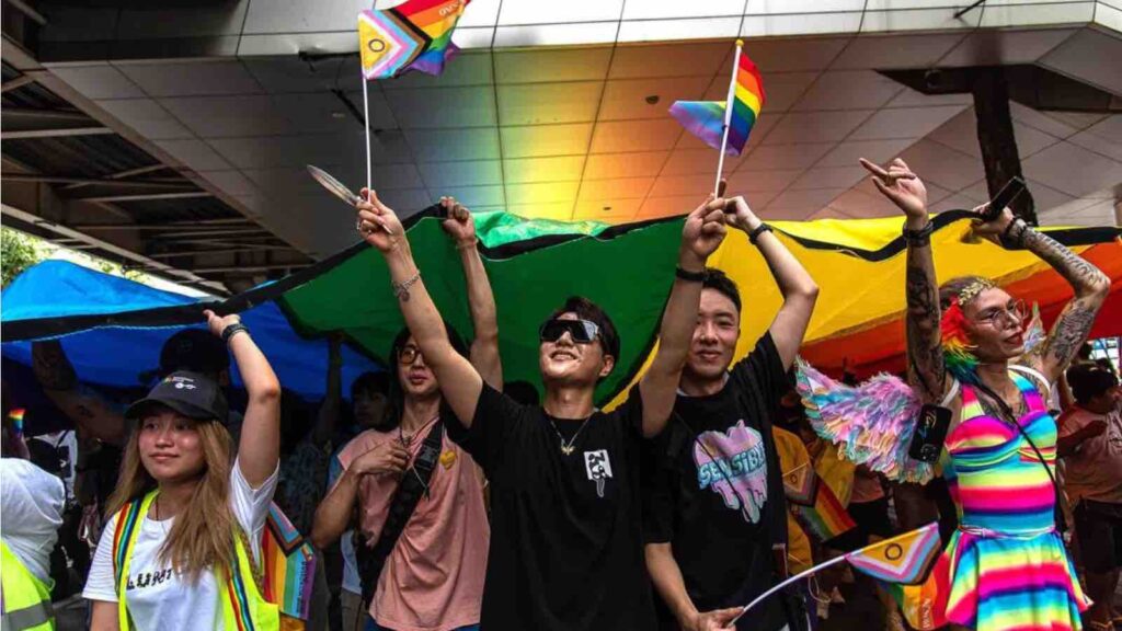 Participants march on Sukhumvit road while holding a rainbow flag during the Bangkok Pride Parade 2024, in Bangkok, Thailand, on June 1, 2024. Peerapon Boonyakiat/SOPA Images/LightRocket/Getty Images