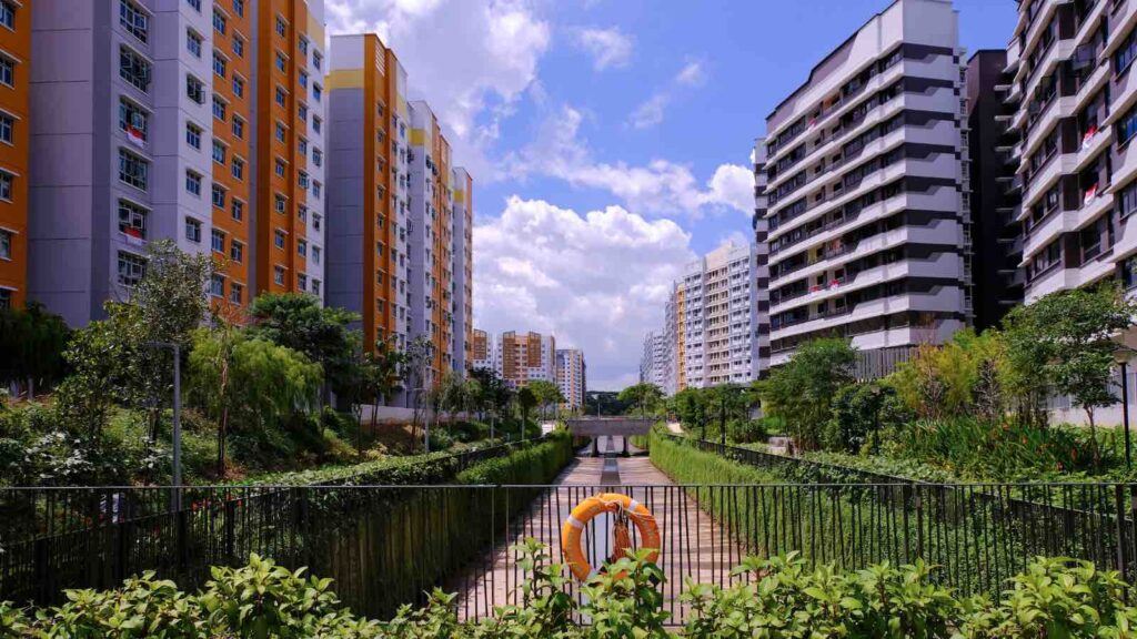 Bright colorful HDB flats buildings in Singapore, against cloudy blue sky. Panoramic view by Kandl from Getty Images