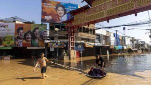 People drag their belongings through floodwaters in Chiang Mai Province, Thailand, Sunday, Oct. 6, 2024 as the city’s main river overflowed its banks following heavy seasonal rainfall. (AP Photo/Wason Wanichakorn)