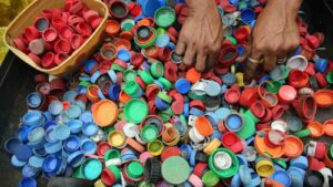 plastic pollution : Person Hands on Assorted-color Plastic Lid Lot by Krizjohn Rosales from Pexels