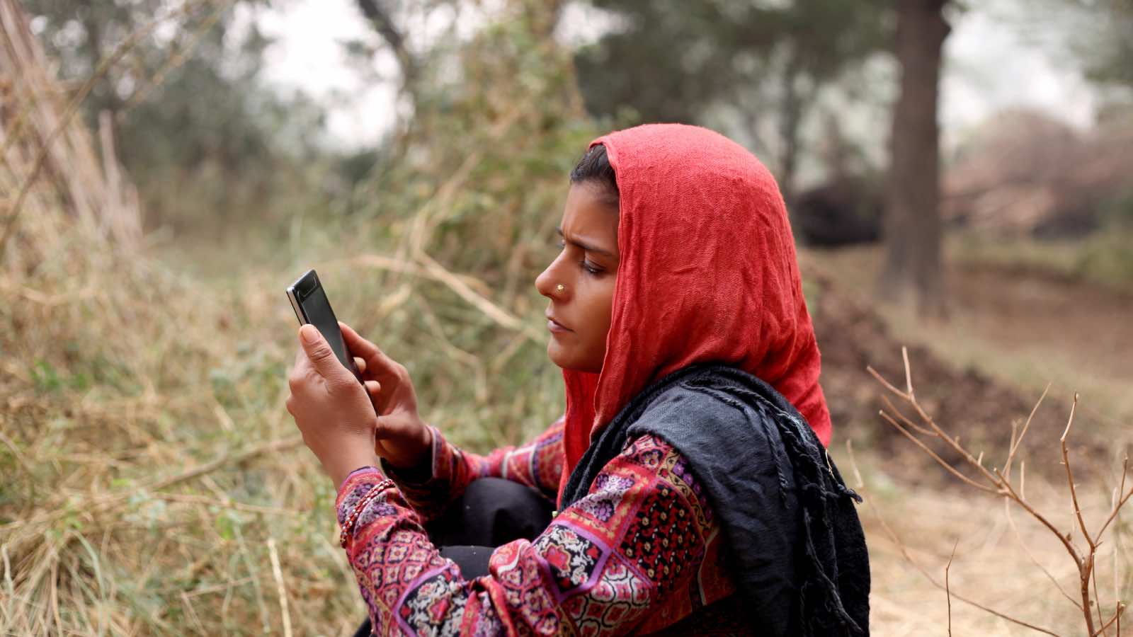 Indian women using mobile phone by pixelfusion3d from Getty Images Signature